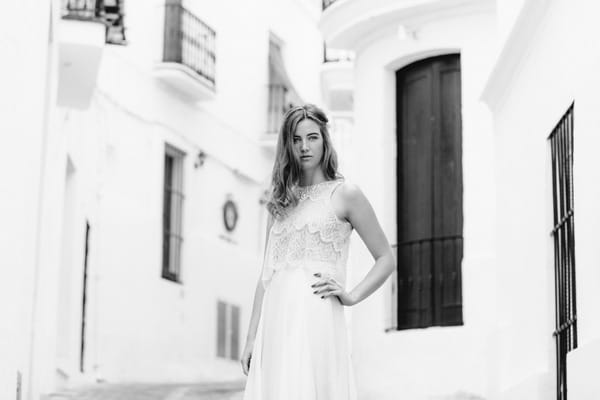 Bride with hand on hip in street in Spain