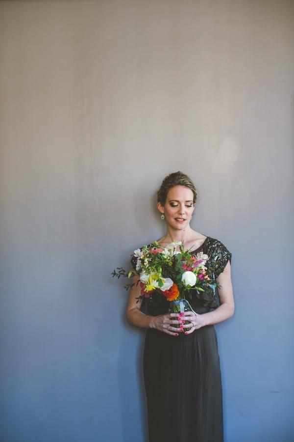 Bride in mink dress holding bouquet