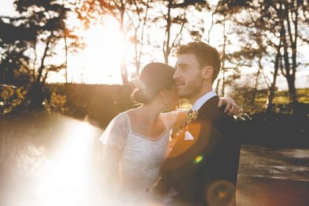 Bride and groom hugging in hazy sunshine - Picture by Claire Basiuk Photography