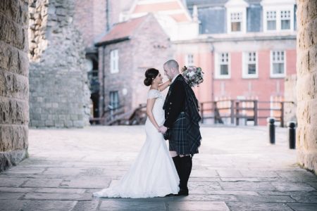 Bride and Scottish groom in kilt facing each other - Picture by Lucie Watson Photography