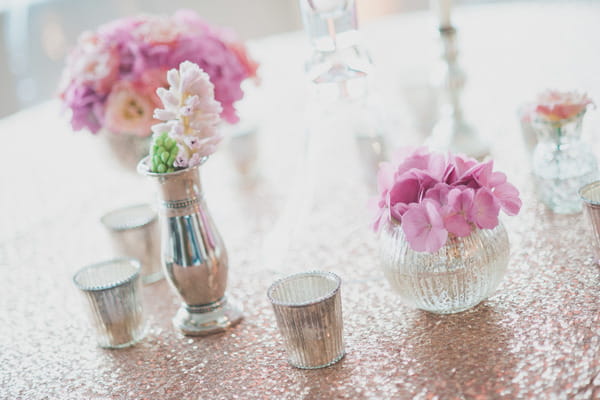 Pink flowers in metallic votives