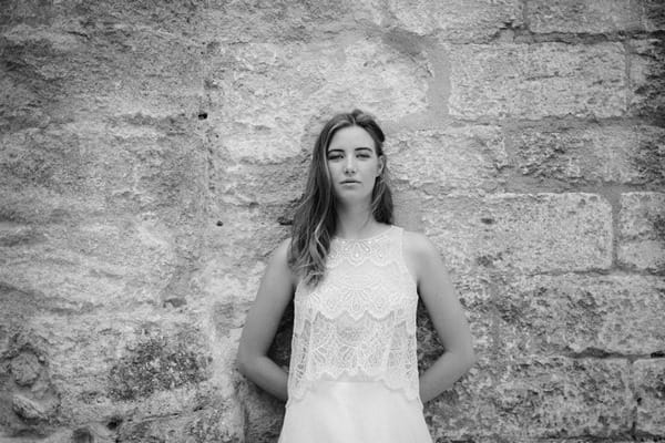 Bride standing against wall