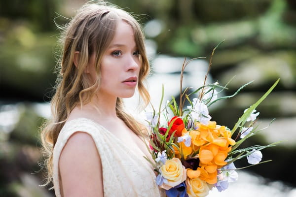 Bride with hair down holding bouquet