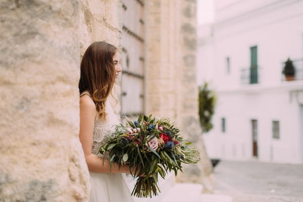 Bride holding large rustic wedding bouquet