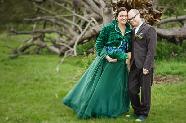 Bride in green wedding dress standing with groom