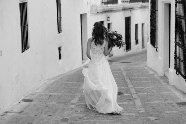 Bride walking down street in Spain