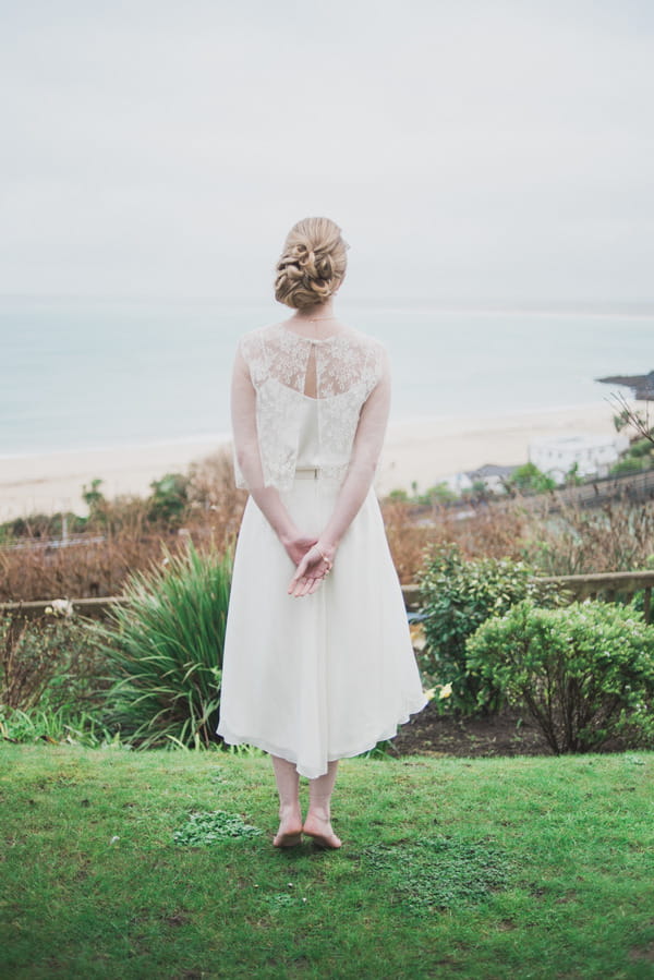 Bride standing with hands behind back