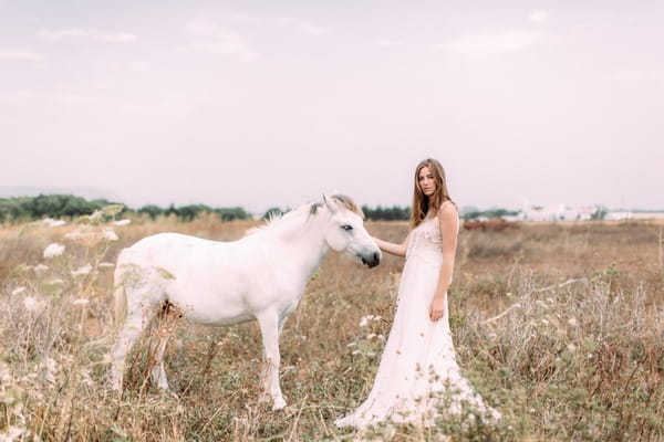 Bride in field with horse