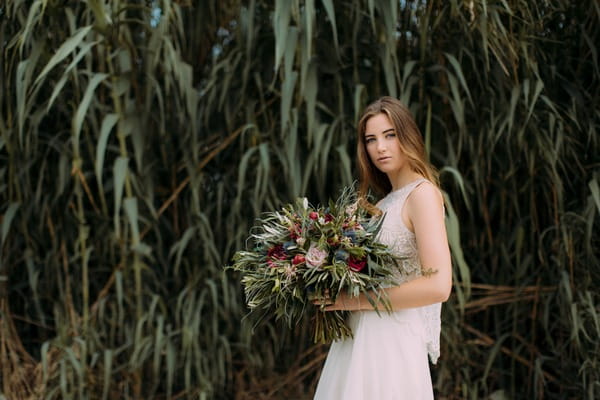 Bride holding large rustic wedding bouquet