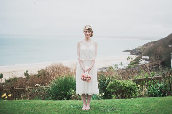 Bride standing up straight holding bouquet