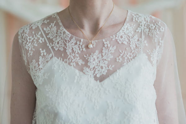 Lace detail on front of bride's wedding dress