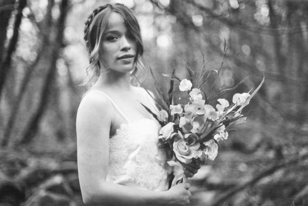 Bride with hair plait holding bouquet