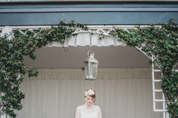 Bride standing under hanging lantern