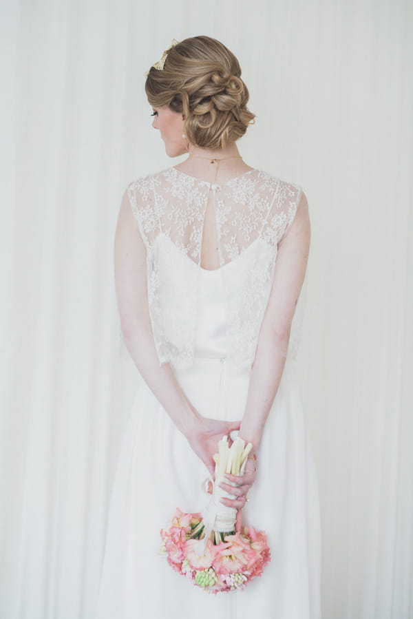 Bride holding bouquet behind back