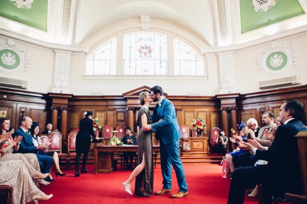 Bride and groom kiss in Islington Town Hall