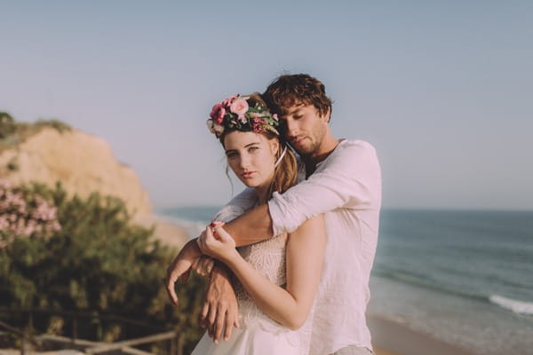 Groom resting head against boho bride