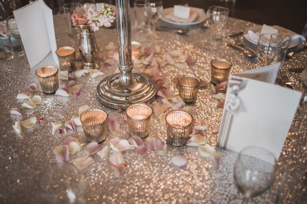 Tea lights on gold metallic wedding table cloth