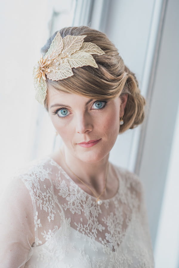 Bride with leaf hair accessory staring at camera