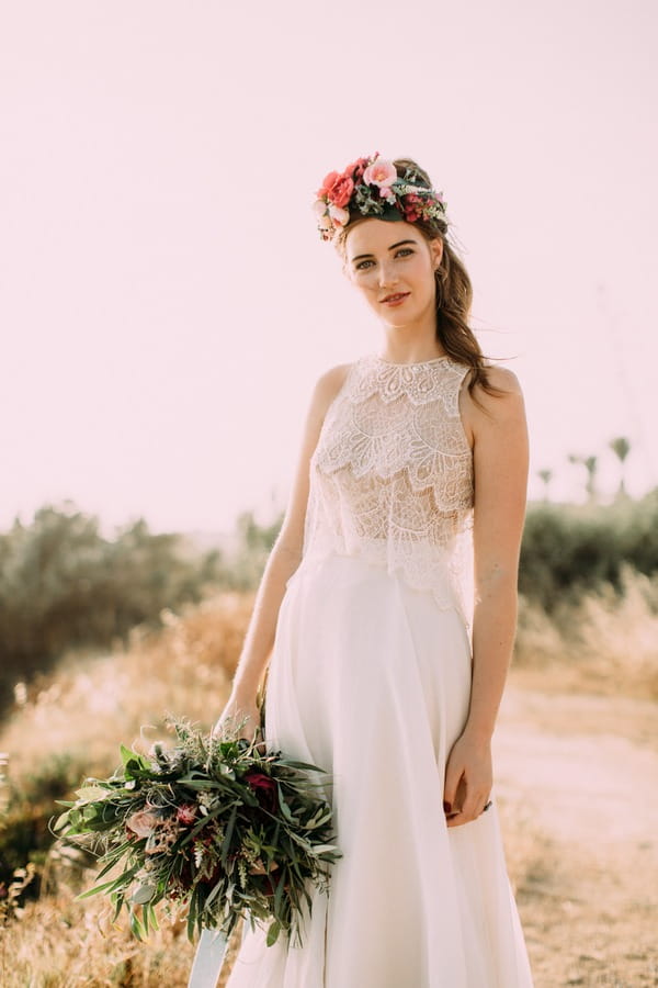 Bride with flower crown holding bouquet