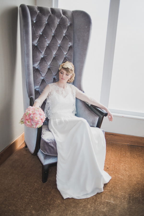 Bride sitting in grey chair