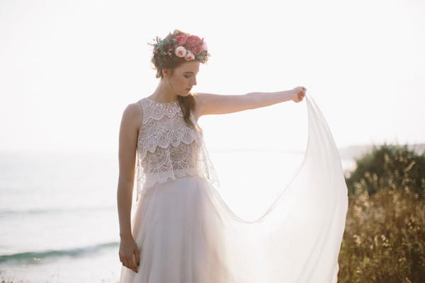 Bride holding out dress