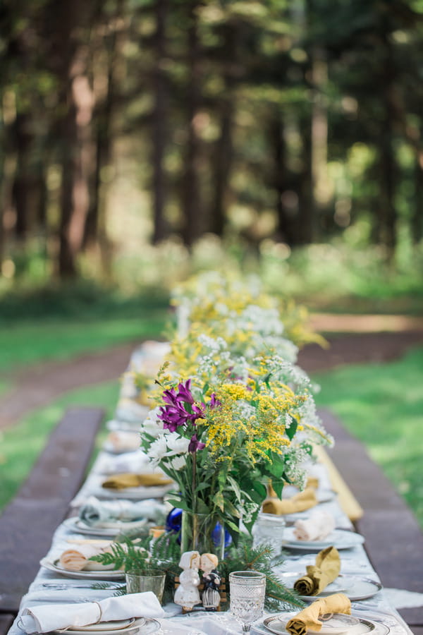 Flower centrepieces on long wedding table