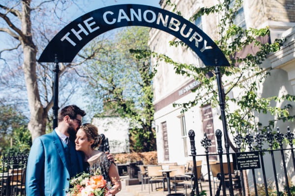 Bride and groom in front of The Canonbury sign