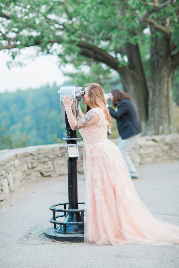 Bride and groom looking through binoculars at Letchworth State Park
