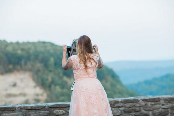 Back of bride looking through binoculars at Letchworth State Park