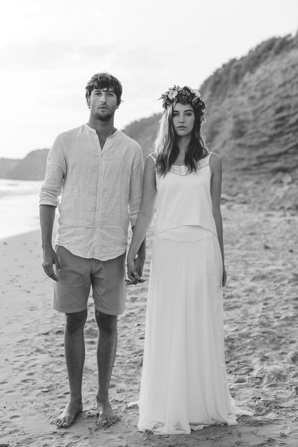 Boho bride and groom standing up straight