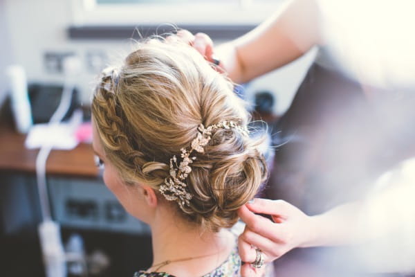 Bride's updo with plait and flowers