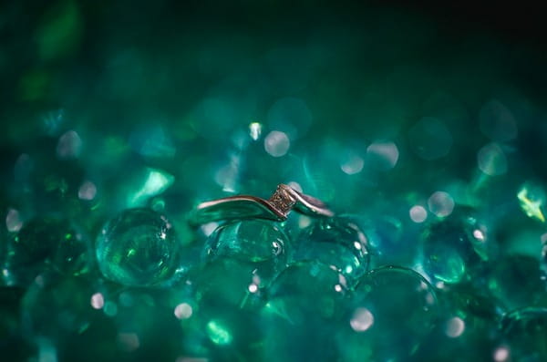 Wedding ring in green stones