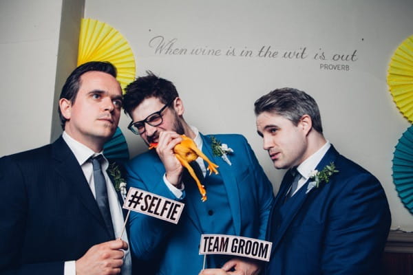 Team groom in wedding photo booth