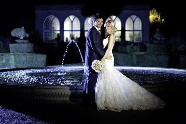 Bride and groom by fountain at Warwick Castle