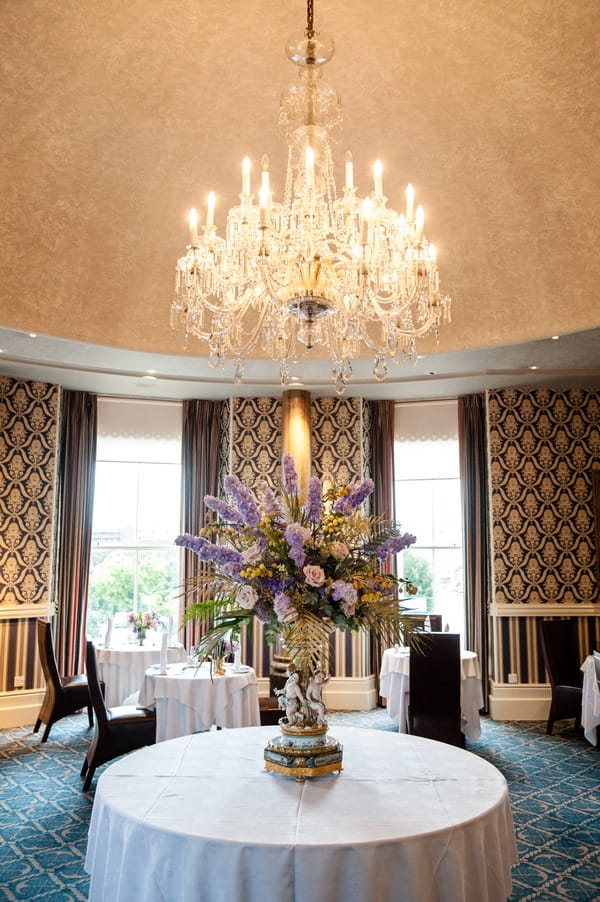 Large floral display under chandelier at The Duke of Cornwall Hotel