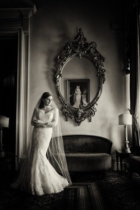 Bride standing by mirror - Picture by Pauls Studio