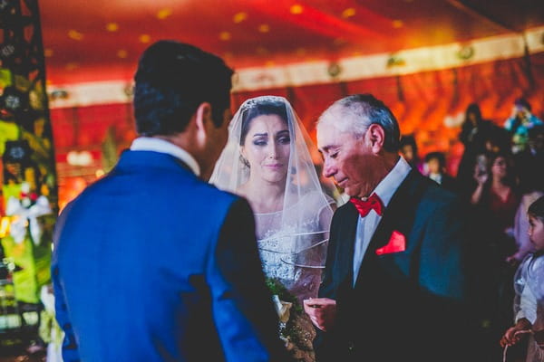 Bride with father and groom at altar