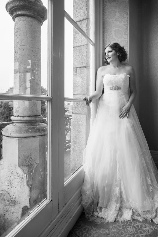 Bride looking out of window at The Duke of Cornwall Hotel