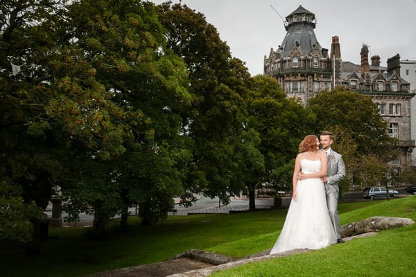 Bride and groom in grounds of The Duke of Cornwall Hotel