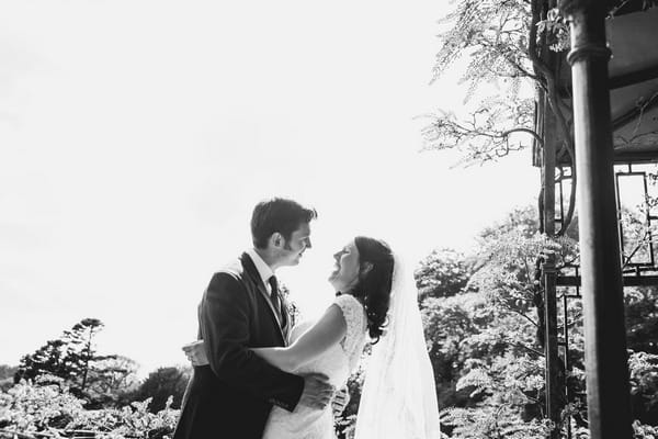 Bride laughing as groom leans in to kiss