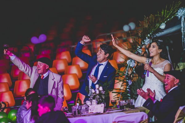 Bride and groom punching the air during speech