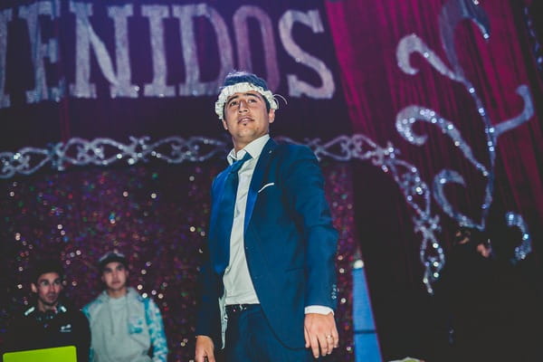 Groom with bride's garter on head