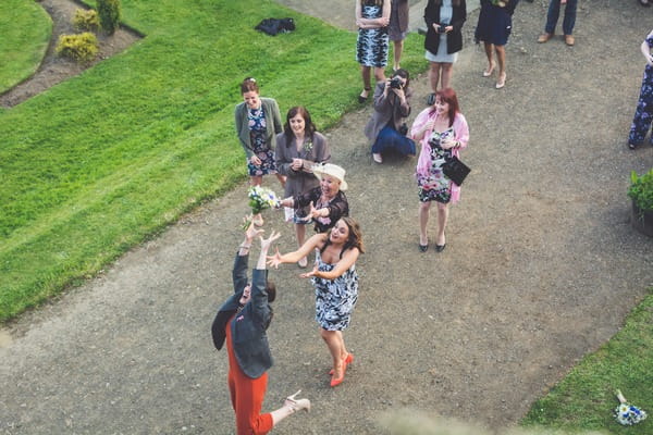 Lady catching bride's bouquet