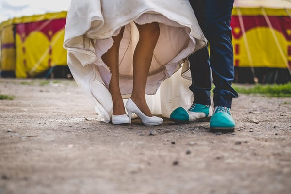 Bride and groom's legs with groom in clown shoes