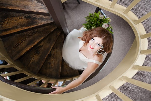 Bride on spiral staircase at The Duke of Cornwall Hotel