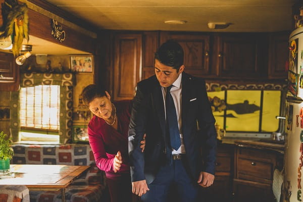 Groom's mother helping with suit