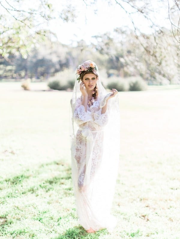 Bohemian bride wearing lace robe and flower crown