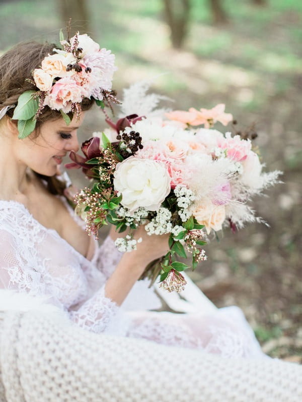 Bohemian bride holding large pastel wedding bouquet