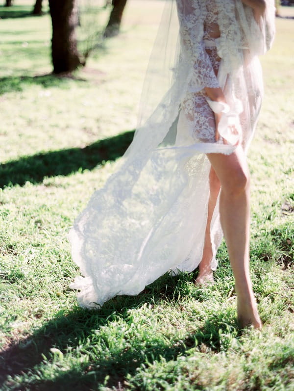 Bride's legs as she walks on grass