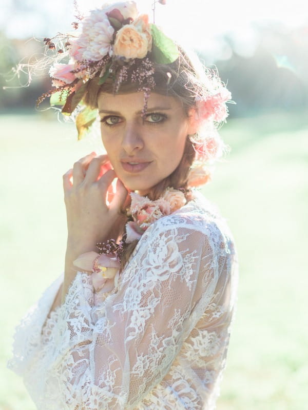 Bohemian bride with flower crown and lace detailed wedding robe